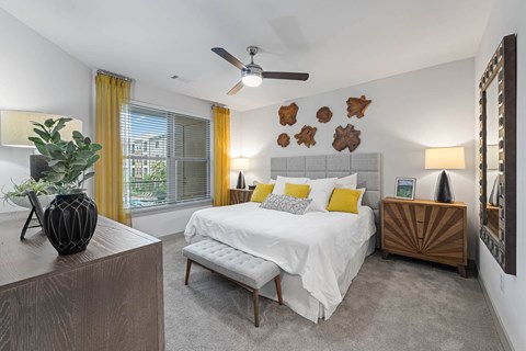 a bedroom with a bed and a ceiling fan